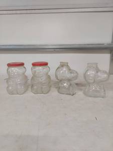 lot 1372 image: Glass Teddy Bear Storage Jars with Red Lids and Snoopy Glass Banks