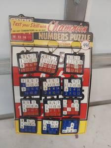 lot 2239 image: Champion Numbers Puzzle Key Chain Set Display Board
