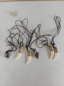 lot 1059 image: Tooth and Skull Pendant Necklace Set