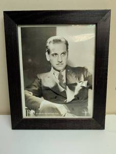 lot 16880 image: Melvin Douglas 1930s Hollywood Studio Portrait by Metro Goldwyn - Mayer in Dark Wood Frame