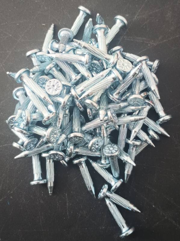 lot 554 image: Zinc-Plated Concrete Nails - Bulk Pack (Count of 98) - Retail $12