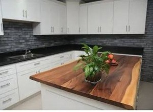 lot 25043 image: Hampton Bay 4 ft. L x 25 in. D Finished Saman Solid Wood Butcher Block Countertop With Live Edge- Retail $349