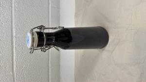 lot 96 image: Black Glass Swing Top Bottle with Ceramic Cap