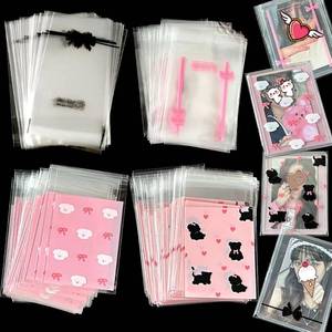 lot 61918 image: 200 Pcs Resealable Cellophane Bags, Self-Adhesive Cookie, Candy & Dessert Bags - Small Pink Bow, Clear Candy Card Sleeves - Pack of 200 - Retail $9