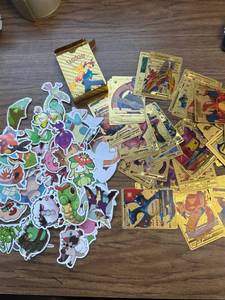 lot 855 image: 100 vinyl Pok mon stickers, 55 rare gold Pok mon cards package.