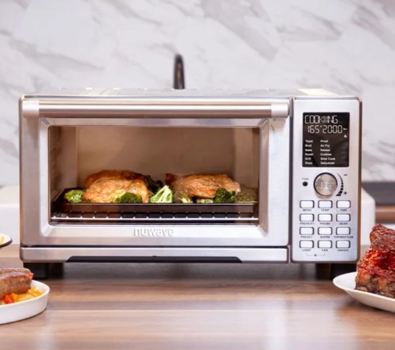 lot 61633 image: Nuwave Bravo Pro XL Convection Oven and Air Fryer with Probe. MISSING SHELVES. DENTED Inside Top Left Corner.  Door Seems to Shut Correctly. See Last Two Photos. - Retail $249