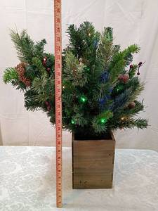 lot 21 image: Pre-lit Artificial  Tree in Wooden Box 24 inches tall