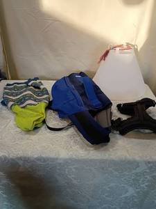 lot 111 image: Dog lot including cone, sweater, and harnesses.