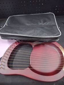 lot 18309 image: A 16 string Lyre harp with replacement strings and bag
