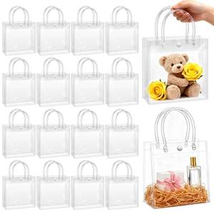 lot 32815 image: BadenBach 10 Pack Clear Gift Bags with Handles, 6.9 x 6.9 x 3.5 Small Reusable Plastic Party Favor Bags Bulk, Transparent PVC Tote Bag for Wedding, Birthday, Mothers Day Boutique (17.5x17.5x9 cm) - Retail $12
