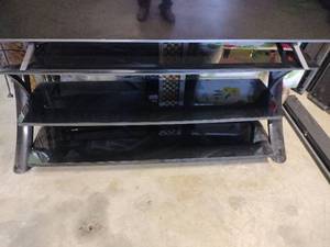 lot 13883 image: Modern Black Glass TV Stand with Metal Frame - Retail $65