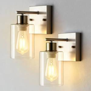 lot 15834 image: 2-Pack Bathroom Wall Sconces, Brushed Nickel Vanity Lights, Modern Wall Light Fixture with Clear Glass Shade, Farmhouse Wall-Mount Lighting Lanterns, Wall Lamps for Mirror Living Room Bedroom Kitchen - Retail $40