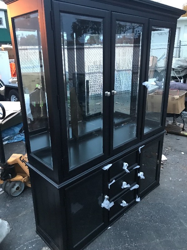 lot 895 image: Very nice high dollar china cabinet with glass shelves lights up top and bottom with touch has small shipping scuff on right side easy fix with black paint touch up dont miss this high dollar cabinet