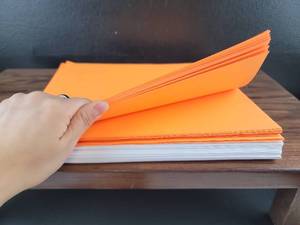 lot 2585 image: Orange and White Paper Stack computer paper