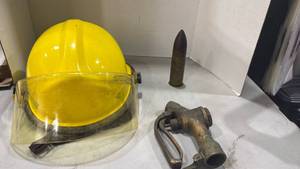 lot 2041 image: Structural firefighter helmet, 37mm bullet and brass gas pump nozzle
