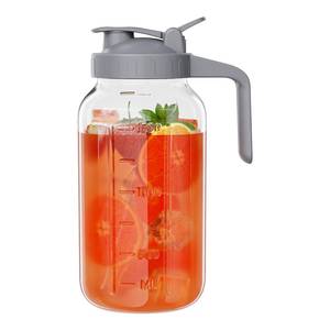 lot 19732 image: Glass Mason Jar Pitcher, 64 oz Wide Mouth Jug with Pour Spout Handle Lid for Cold Brew Coffee, Ice Beverage, Iced Juice, Lemonade, Sun Tea, Fruit Drinks Container