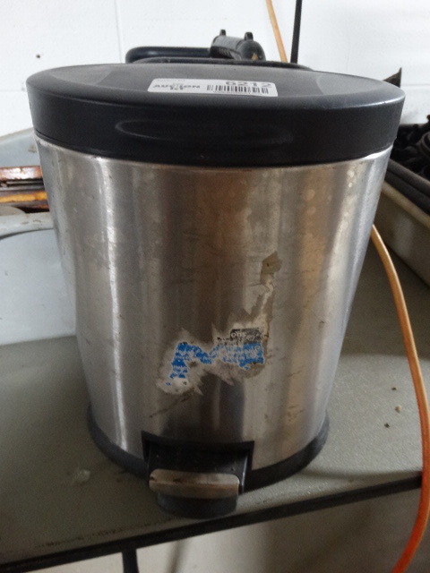 lot 6212 image: Small metal foot petal trash can.