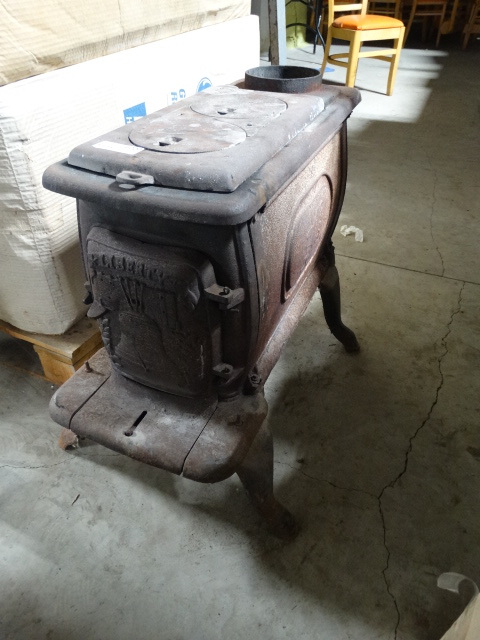 lot 6220 image: Cast iron wood burning stove.