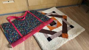lot 1228 image: Rug 33 inches square and a cloth portfolio