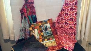lot 1301 image: Two aprons, table runner and mesh bag