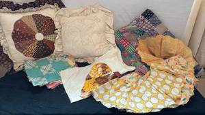 lot 1312 image: Two throw pillows and some unfinished quilting pieces