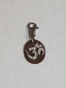 lot 1009 image: Silpada .925 Crystal Om Symbol Brass Charm
