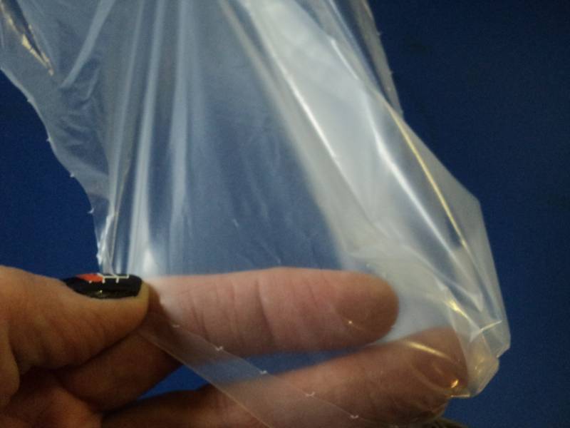 lot 3537 image: (1) roll clear plastic pallet wrap- damaged,  box knife cut through several layers