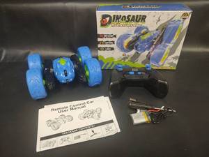 lot 491 image: NIB Dinosaur RC Stunt Car with 360° Rotation, 2.4 Control and More