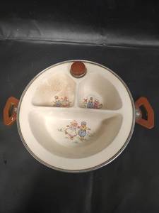lot 591 image: Vintage Childrens Three-Section Ceramic Warming Dish with Chrome Warmer and Bakelite Handles. Including Dutch children illustrations