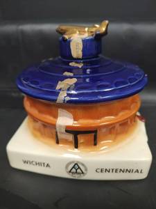 lot 697 image: Vintage 1970 Wichita Centennial Pottery Airplane Whiskey Jug with This Airplane Stopper