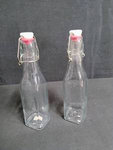 lot 1797 image: Clear Glass Swing Top Bottles with Pink Caps