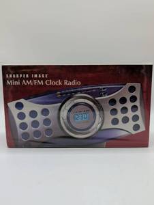 lot 2017 image: Sharper Image Mini AMFM Clock Radio, In Box.