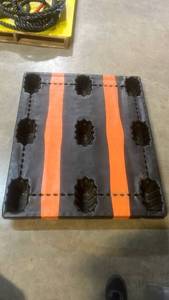lot 50140 image: Black Plastic Pallet with Orange Stripes