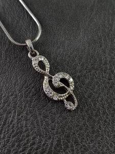 lot 2123 image: Crystal Silver-Toned Treble Clef Pendant Necklace