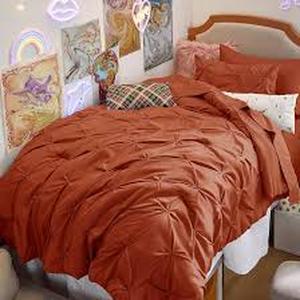 lot 3482 image: Rusty orange bed set. Looks to be twin sized.