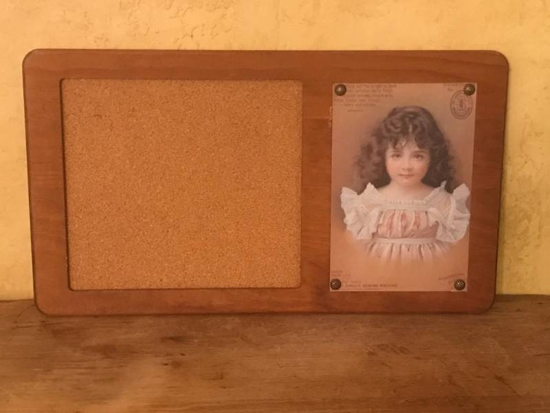 lot 2478 image: Cork Board with Singer Sewing Machine Advertisement