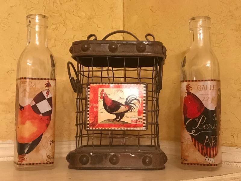 lot 2582 image: Rooster olive oil bottles and wire basket