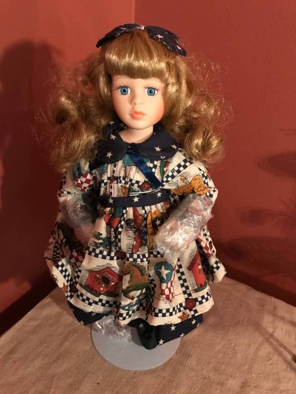 lot 2602 image: Ceramic 13 doll with stand