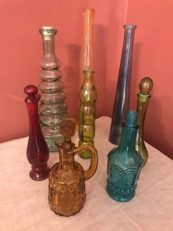 lot 2637 image: Assorted colored unique shaped glass bottles (some with stoppers).  Tallest bottle is 11