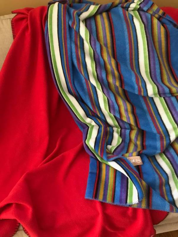 lot 2686 image: Set of throw blankets-Red fleece Kansas City Chiefs and multi colored fleece  (perfect for football gamestail gates)