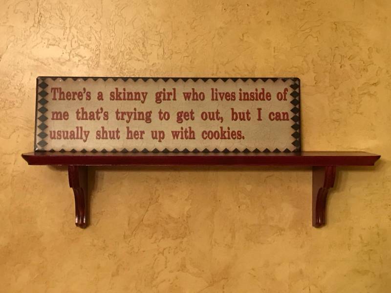 lot 2698 image: Red Wood Shelf (23 length) and Tin Skinny girl Cookie sign (5 12 x 19)