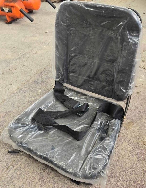lot 4177 image: Unused Universal Equipment Seat with Safety Belt designed for a wide range of construction and agricultural equipment. Features integrated safety seat belt, pre-drilled mounting points, and durable metal frame construction