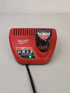 lot 95 image: Milwaukee M12 Battery Charger Plus Battery