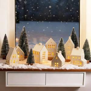 lot 6319 image: Mokof Christmas Village Set - 7 White Ceramic Houses with Remote LED Tea Lights and 8 Mini Trees, Farmhouse Christmas Decorations Indoor for Fireplace, Mantel, Tabletop, Shelves Winter Holiday Decor