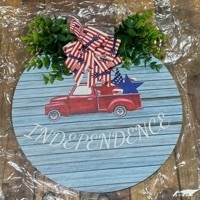 lot 5386012 image: Red Truck Independence Day Wooden Round Sign with Greenery - Retail $9