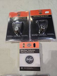 lot 1493 image: Harley-Davidson Siren Disc Brake Lock & Ride Free Medallion Set