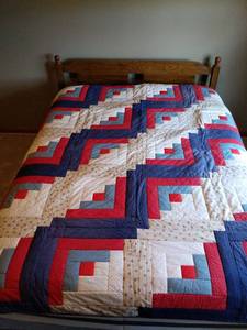 Handmade Americana Log Cabin Pattern Quilt. Shown on a queen bed for scale.