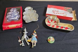 lot 202 image: Holiday Decorative Collection Bundle - Snowman Candy Tray, Silver-plated Candy Cane dish, two Wizard of Oz themed ornaments, and a small wood bunny made in East Germany