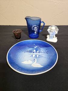 lot 205 image: Shirley Temple Blue Pitcher, Dutch Boy Ceramic Figurine, 1974 Bing & Grondahl (plate # 9074) Collectors plate from Denmark, and a small Cranberry colored shot glass with gold toned etching