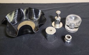 lot 207 image: Set of 4 Vintage Record Player Weights (3 metal, 1 glass) and a Chip Bowl made from a record